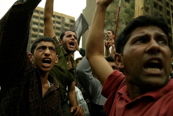 Thousands of Iraqi Shi'ite muslims from Najaf protesting in the streets of Baghdad over the US arrest of their leader Mohammed Al-Fartosi. April 2003