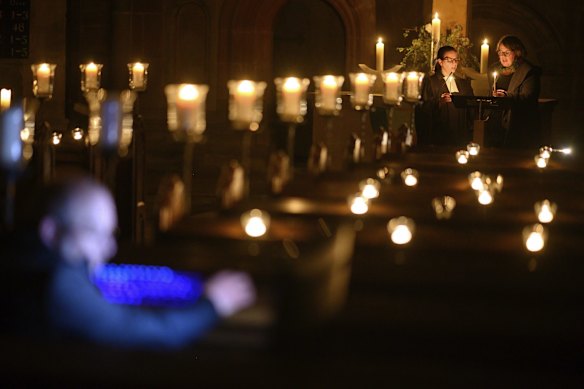 Ulrike Gaiser, right, parish councillor, and pastor Christine von Wagner, left, pray during the Easter Vigil service in the Lutheran monastery church which will be transmitted via live stream, in Maulbronn, Germany.