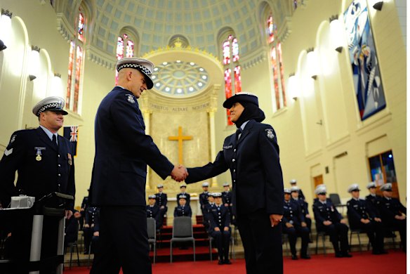 Chief Commssioner Simon Overland welcomes new recruit Yasemin Savaran, who has become the second police officer to wear traditonal Muslim hijab during graduation ceremony in the Victoria Police Acadamy chapel on the 25th of June,  2010. Picture by Craig Abraham