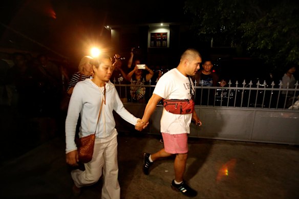 Michael Chan, right, the brother of Bali Nine heroin smuggler Andrew Chan, holds the hand of Andrew's girlfriend Febyanti Herewila as they leave Kerobokan Prison after being refused one final visit before the transfer by prison authorities. 