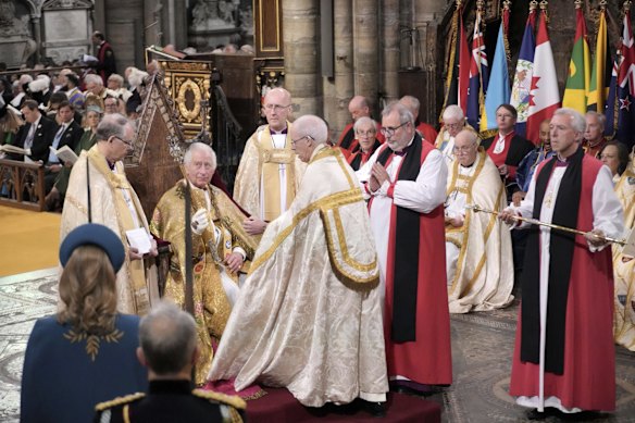 King Charles III holds the Sovereign's Sceptre with Cross during the coronation ceremony at Westminster Abbey.