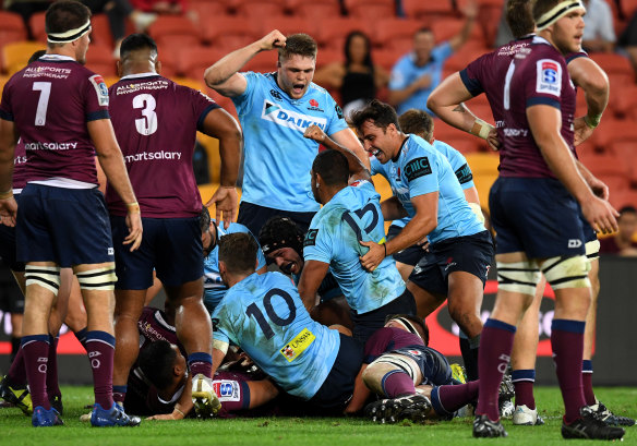 Against the odds: Kurtley Beale scores for the embattled Waratahs in the win over the Reds.
