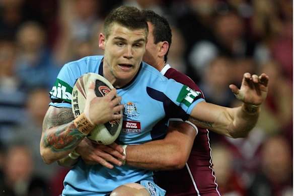 Josh Dugan of the Blues is tackled during Origin one.