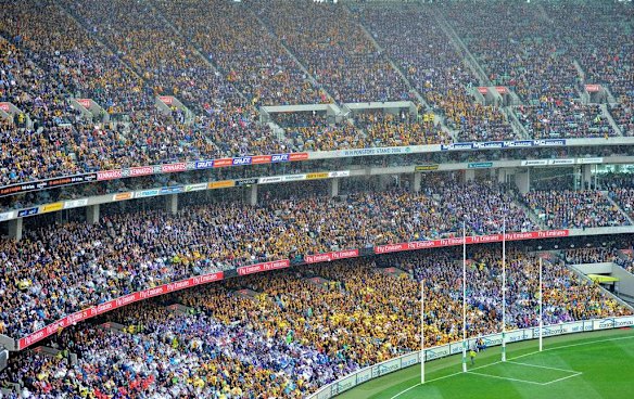 The 2013 AFL Grand Final at the MCG with the Hawthorn cheer squad located near the goal posts.