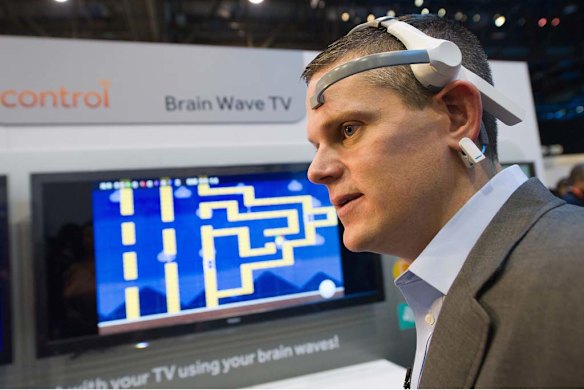 An attendee tries out a brain wave television made by Haier at the Consumer Electronics Show in Las Vegas.