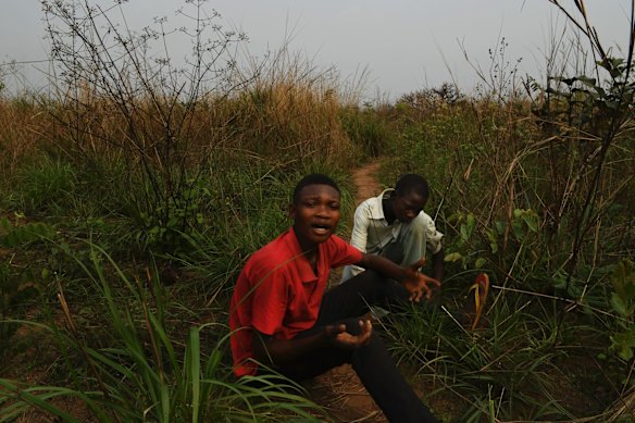 Orphan brothers Michael Kena Kuida, 17 (left), and Donnat Basombeshayil, 14,  sit where they had hidden from soldiers when their village Kamuandu in Kasai Central was attacked. They fled after witnessing both their mother Ntumba Tshibuabua carrying their baby brother Mado shot and killed by soldiers. They talked of how they cried for days, had no food and ended up living in the bush for 1 year. They now live with their grandparents.  