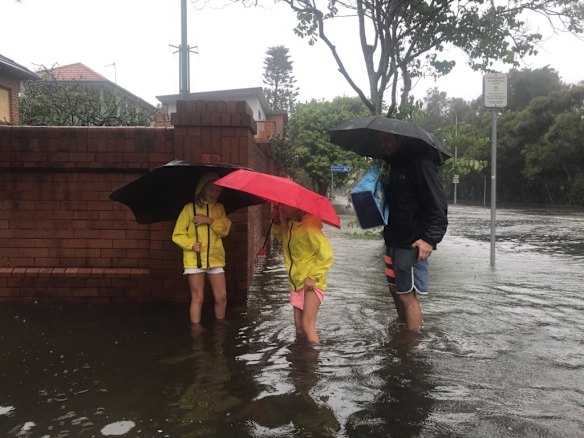 People try to cope with flood waters at corner Golf Parade and Balgowlah road Manly.