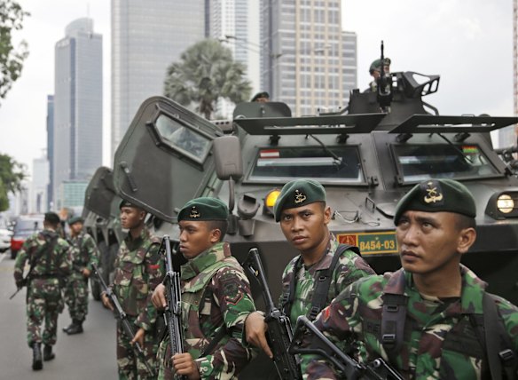 Indonesian soldiers stand guard near the site where an explosion went off in Jakarta, Indonesia Thursday, Jan. 14, 2016.