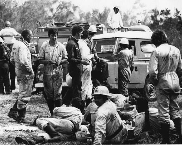 Firefighters at the Control Point on the Wakehurst Parkway, near Narrabeen, take a brief respite from their toil. October 4, 1971.