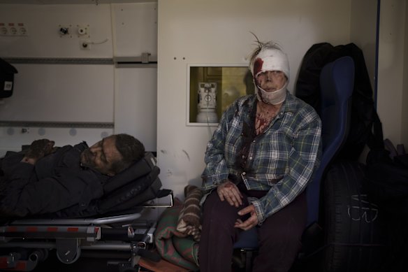 Injured civilians sit in an ambulance before being taken to a hospital after a Russian attack in Kharkiv, Ukraine.