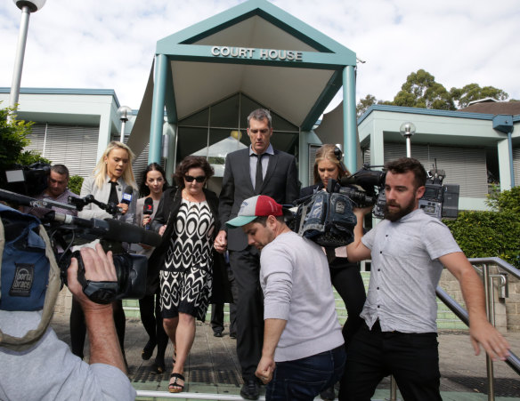 Julie Goodwin and her husband, Mick, run the media gauntlet after she was convicted of drink driving charges in Gosford last week.