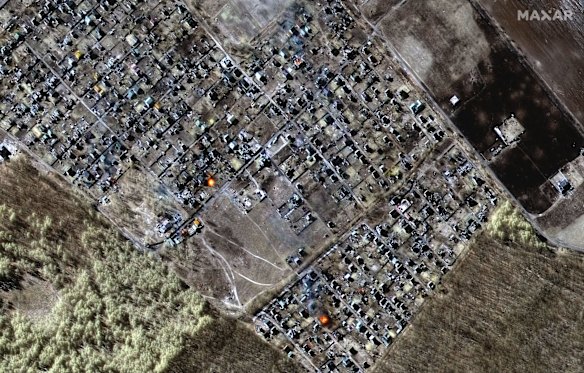 This multispectral satellite image provided by Maxar Technologies shows destroyed homes, impact craters and fires in town of Moschun, Ukraine, during the Russian invasion.