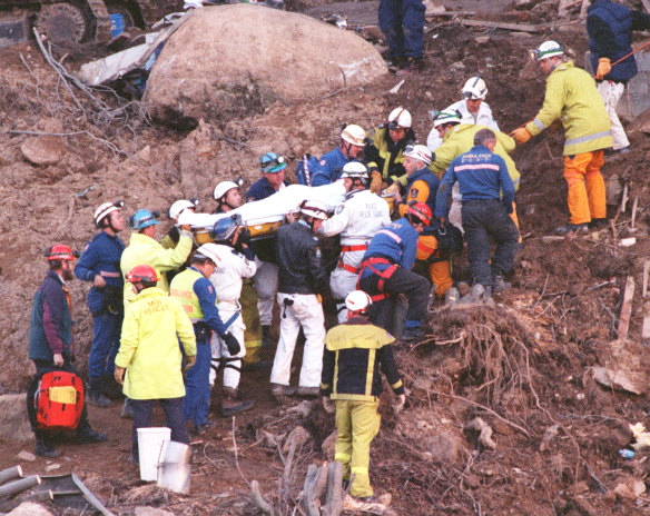 Stuart Diver is carried to safety after rescuers tunnelled through 2m of concrete to free him.