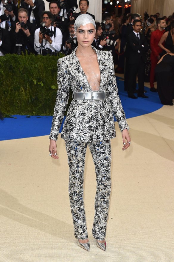 Cara Delevingne showcased one of the hair trends of the night, painting her shaved scalp in silver.
