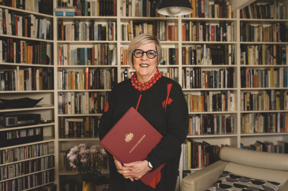 Marriage celebrant Judy Aulich, in front of the bookshelves in her living room where she often marries her clients.