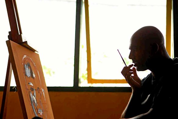 Bali Nine member Myuran Sukumaran paint a self portrait following instruction from Australian artist Ben Quilty in the Kerobokan jail.