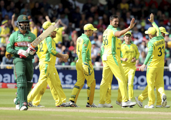 Mitchell Starc, third right, celebrates with teammates after the dismissal of Bangladesh's Tamim Iqbal.