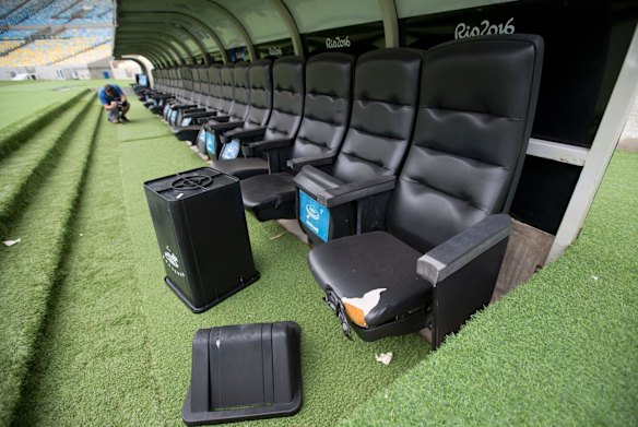 A rubbish bin lays by ripped seats at one of the dugouts in Maracana stadium in Rio de Janeiro.