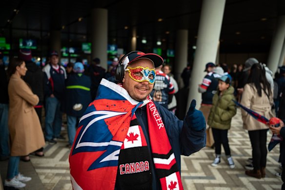 A Roosters supporter arrives for the stadium's debut.