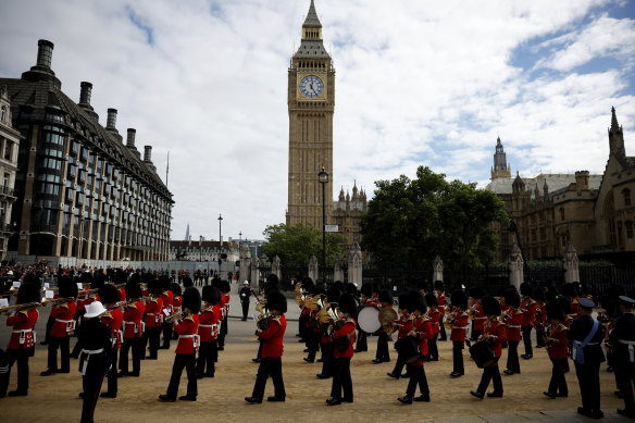 A marching band walks past Big Ben following Queen Elizabeth’s funeral.