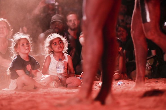 Children watch a performance during the community event to celebrate the closure of the Uluru climb.