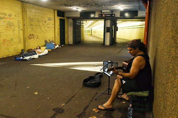 Busker Joe Trueman entertains homeless people and the odd pedestrian at St James station. March 31, 2020