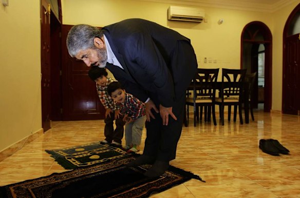 Khalid Mishal (right) prays with his grandsons Bara 4yrs (left) and Saad 2yrs (2nd from left) at a private house in Doha, Qatar.
