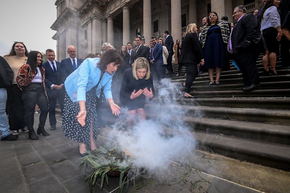 Opposition leader Jess Wilson taking part in a smoking ceremony on the steps of parliament.
