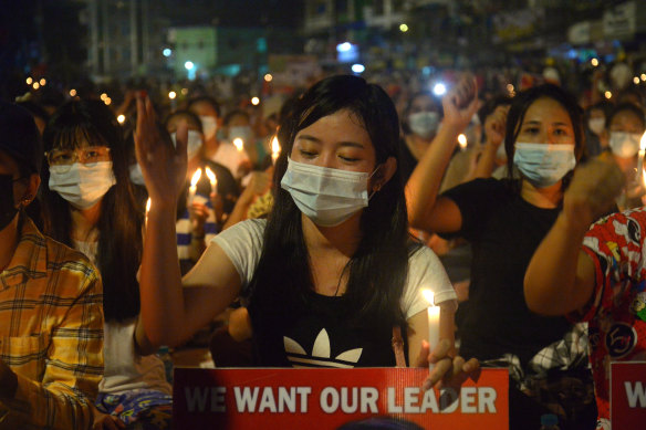 Protesters attend a candlelight night rally in Yangon on Saturday night. 