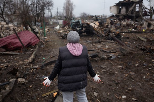 Natalia Hrom, a local resident, reacts as she describes the destruction in the village in Svitylnia.