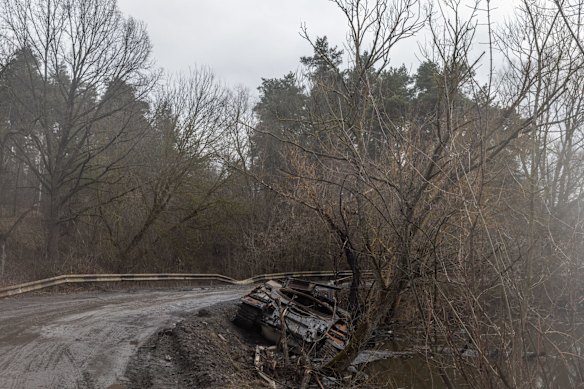 A destroyed Russian military vehicle is seen on a road on the outskirts of Trostyanets. 