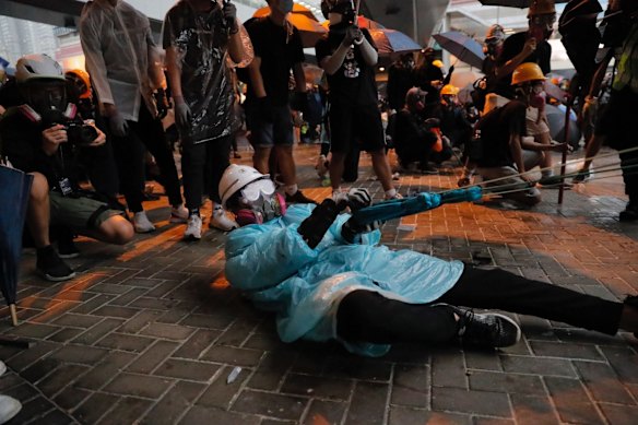 A protester prepares to hurl an object at police officers.