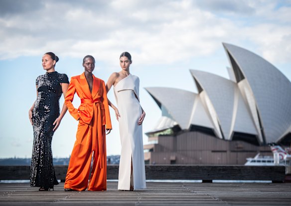 Models Cameron Stephens, Miji Awakyr and Marisa Pavela wearing Carla Zampatti at Circular Quay in Sydney, where Australian Fashion Week returns on Monday.