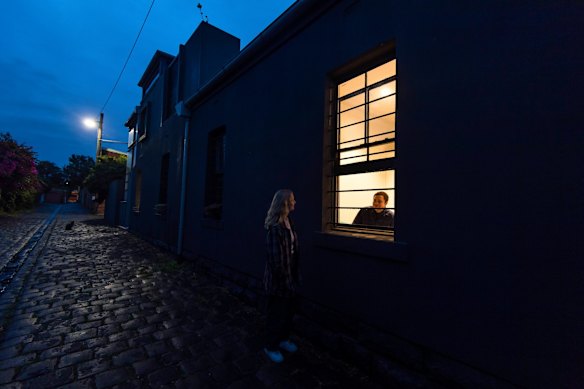 Tom Davis photographed on his tenth day of isolation after returning from a working holiday in Canada. Close friend and neighbour Olivia McLeod making one of her regular visits to chat at Tom's window.
