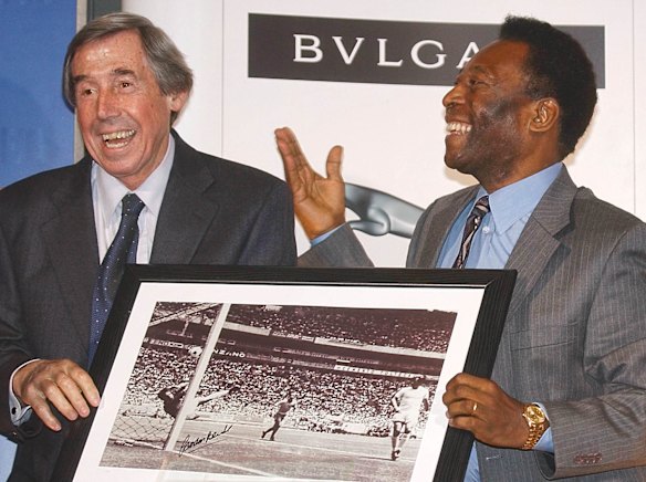 Brazilian soccer legend Pele, right, presents former England goalkeeper Gordon Banks, with a photograph showing Banks saving a header from Pele, right in photo, in the 1970 Mexico Soccer World Cup, 2004.