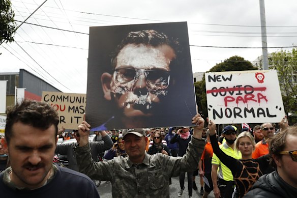 Anti-lockdown protesters march along Burnley Street in Richmond in Melbourne. Protesters gathered despite current COVID-19 restrictions prohibiting large outdoor gatherings. Metropolitan Melbourne is currently subject to lockdown restrictions as health authorities work to contain the spread of the highly contagious Delta COVID-19 variant, with people only permitted to leave their homes for essential reasons.