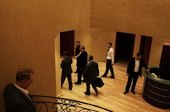 Khalid Mishal (4th from right) is surrounded by his bodyguards after a meeting at a house in Doha, Qatar.