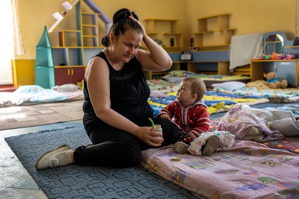 Nadia, 42, with her daughter 10-month-old daughter Katya, take shelter in a kindergarten in Kryvyi Rih. Nadia described how she covered the infant with her own body while hiding in the basement during Russian shelling of her village of Skadovsk, now under Russian control, in the southern Kherson region. She was evacuated by volunteers to safety and plans to relocate to western Ukraine. 