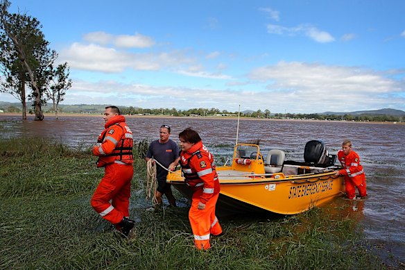SES workers return from a sweep of flood waters in Beaudesert.