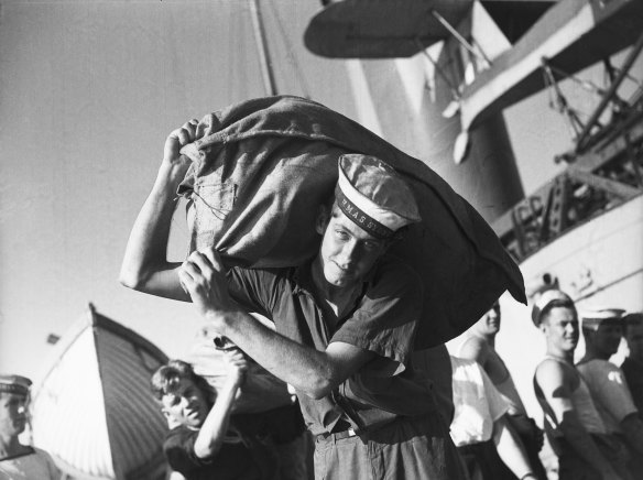 After the official ceremonies, the “liberty men” - the first lucky batch for leave - carried ashore their baggage. February 10, 1941.