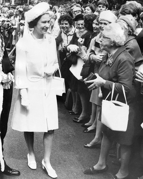Queen Elizabeth II greets a crowd.