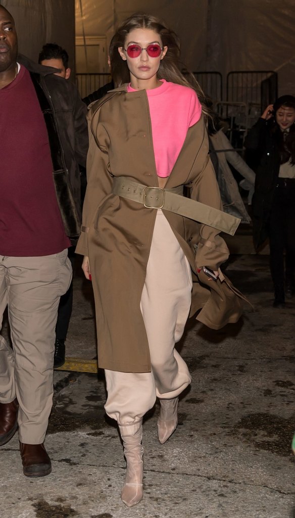 Just add hot pink ... Gigi Hadid does the trench-meets-Flashdance-shoulder look.