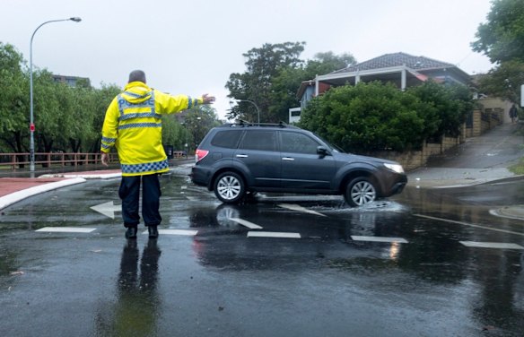 Traffic on The Cresent, Annandale, is diverted due to flooding, as torrential rain and storms hit Sydney.