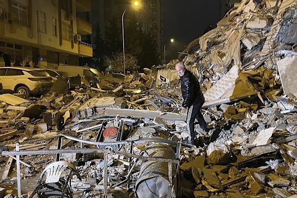 A man searches collapsed buildings in Diyarbakir in south-east Turkey.