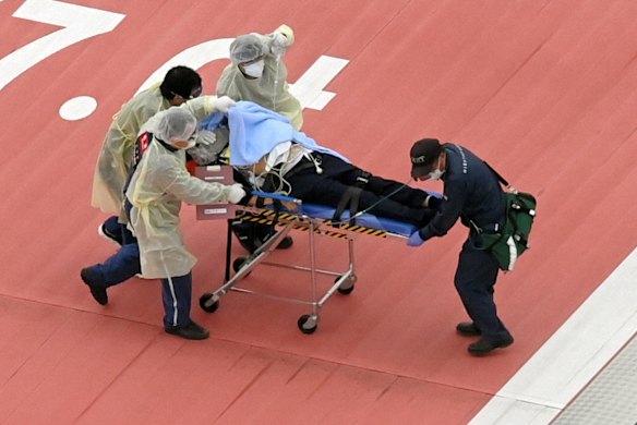 Former Prime Minister Shinzo Abe is stretchered to a helicopter after being shot while making a street speech in front of Yamatosaidaiji Station.