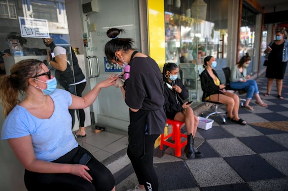 Paris having her nails done at Best Nails Ever on Acland Street, St Kilda, whilst other wait patiently. 