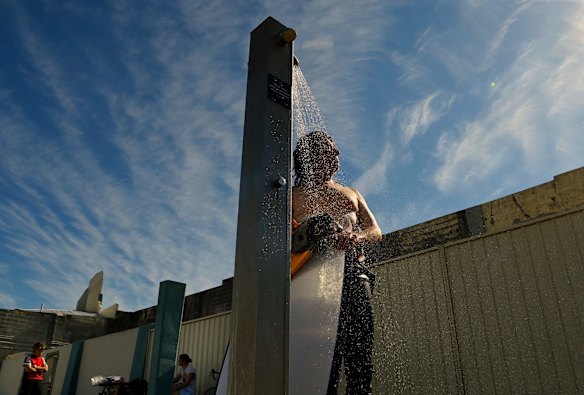JR rinses off near the ocean baths at Newcastle, as temperatures rise during lockdown.
