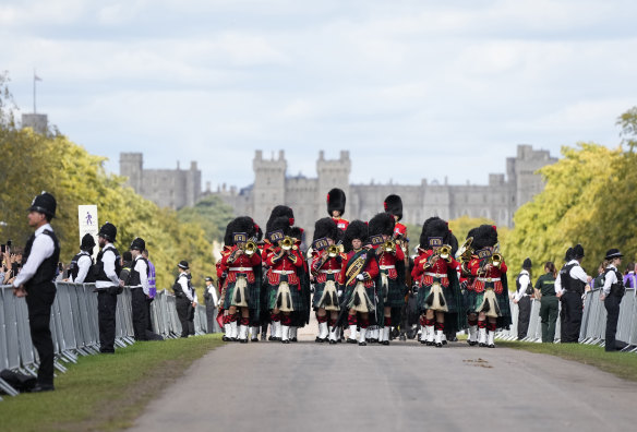 The band of the Royal Regiment of Scotland plays ahead of the arrival of the coffin of Queen Elizabeth II outside Windsor Castle.