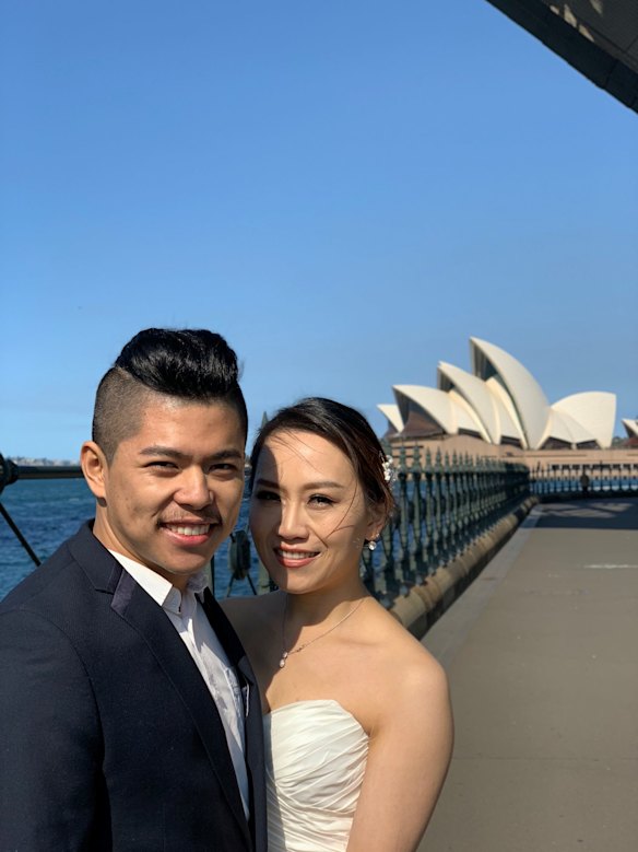 A newly married couple under the harbour bridge in Sydney. 
