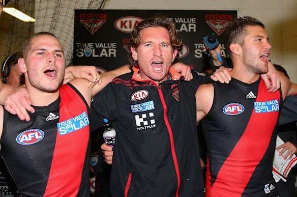 James Hird the coach of the Bombers sings the song with David Zaharakis and Tayte Pears after winning the round 22 AFL match between the Carlton Blues and the Essendon Bombers at Melbourne Cricket Ground on August 24, 2013 in Melbourne, Australia. 